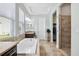 Bathroom featuring soaking tub, walk-in shower and tile flooring at 6007 Quartz Lake Way, Lithia, FL 33547