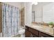 Bathroom features a granite vanity, toilet, and shower with a blue patterned curtain at 6007 Quartz Lake Way, Lithia, FL 33547