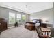 A serene bedroom featuring multiple windows, neutral walls and a ceiling fan at 6007 Quartz Lake Way, Lithia, FL 33547