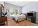 Comfortable bedroom with carpet, a window, blue walls and wooden furnishings at 6007 Quartz Lake Way, Lithia, FL 33547