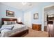 Cozy bedroom with a bed, furnishings, and an open doorway revealing kitchen cabinets at 6007 Quartz Lake Way, Lithia, FL 33547