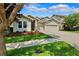 A cozy single-story home featuring a landscaped front yard and a convenient two-car garage on a sunny day at 6007 Quartz Lake Way, Lithia, FL 33547
