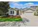 Attractive single-story home with a well-kept lawn and a practical two-car garage under a bright, sunny sky at 6007 Quartz Lake Way, Lithia, FL 33547