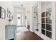 Bright foyer featuring dark hardwood floors, a modern light fixture, and decorative doors at 6007 Quartz Lake Way, Lithia, FL 33547