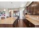 Spacious kitchen features a large island, stainless steel appliances and dark wood cabinets at 6007 Quartz Lake Way, Lithia, FL 33547