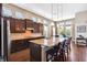 Spacious kitchen featuring a large island with bar seating, stainless steel appliances, and ample cabinet space at 6007 Quartz Lake Way, Lithia, FL 33547