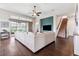 Open living room and staircase with a large neutral sectional couch at 6007 Quartz Lake Way, Lithia, FL 33547