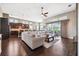 Spacious living room with view to the outdoor pool, plus a neutral sectional couch at 6007 Quartz Lake Way, Lithia, FL 33547