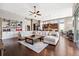 Open-concept living space showcases a large sectional couch and a kitchen in the background at 6007 Quartz Lake Way, Lithia, FL 33547