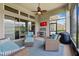Screened patio with blue outdoor seating, ceiling fan, and views of the lawn and neighboring houses at 6007 Quartz Lake Way, Lithia, FL 33547