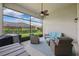 Screened patio with blue outdoor seating, ceiling fan, and views of the lawn and neighboring houses at 6007 Quartz Lake Way, Lithia, FL 33547