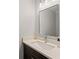 Modern bathroom featuring a dark vanity with light countertop and framed mirror at 605 Bosphorous Ave, Tampa, FL 33606