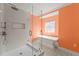 Modern bathroom featuring a walk-in shower and a freestanding bathtub at 605 Bosphorous Ave, Tampa, FL 33606