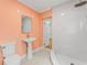 Modern bathroom with unique tiling, a new sink with a pedestal, and a walk in glass shower at 605 Bosphorous Ave, Tampa, FL 33606