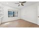 Bright bedroom features tiled floors, ceiling fan, and built in shelving providing ample space at 605 Bosphorous Ave, Tampa, FL 33606