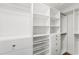 Walk-in closet with custom shelving, drawers, and rods for organizing clothes, shoes, and other accessories at 605 Bosphorous Ave, Tampa, FL 33606