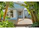 Inviting front porch featuring a wood deck and lush tropical landscaping at 605 Bosphorous Ave, Tampa, FL 33606