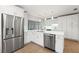 Modern kitchen featuring stainless steel appliances, quartz countertops, and custom cabinets at 605 Bosphorous Ave, Tampa, FL 33606