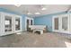 Relaxing lanai with a wicker couch, white cushions, and outdoor ceiling fans offers a bright and comfortable lounge area at 605 Bosphorous Ave, Tampa, FL 33606