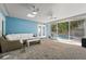 Enjoy this screened-in lanai featuring brick floors, comfortable wicker furniture, and a view of the sparkling pool at 605 Bosphorous Ave, Tampa, FL 33606