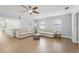 Bright living room with neutral furniture, modern ceiling fan, and tile flooring throughout at 605 Bosphorous Ave, Tampa, FL 33606