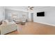 Bright living room with neutral furniture, modern ceiling fan, and tile flooring throughout at 605 Bosphorous Ave, Tampa, FL 33606