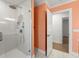Glass enclosed tiled shower featuring a shower head and handheld sprayer and decorative tile flooring at 605 Bosphorous Ave, Tampa, FL 33606
