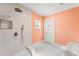 Spacious tiled shower with a shower head and handheld sprayer and tile flooring and access to the exterior at 605 Bosphorous Ave, Tampa, FL 33606