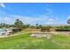 Lush lawn meets a beach with pool views and palm trees, perfect for relaxation at 6600 Sunset Way # 118, St Pete Beach, FL 33706