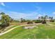 Lush lawn meets a beach with views of the beach and palm trees; perfect for relaxation at 6600 Sunset Way # 118, St Pete Beach, FL 33706