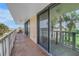 Balcony featuring seating and ocean views, accessible via sliding glass doors, in a serene coastal setting at 6600 Sunset Way # 118, St Pete Beach, FL 33706