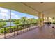 Enjoy tennis court views from this balcony featuring dark railings, brick flooring, and a covered roof at 6600 Sunset Way # 118, St Pete Beach, FL 33706
