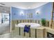 Bright bathroom features an inviting tub with tiled surround and coastal decor at 6600 Sunset Way # 118, St Pete Beach, FL 33706