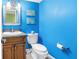 Cozy bathroom with blue walls, a vessel sink, and decorative wall art at 6600 Sunset Way # 118, St Pete Beach, FL 33706