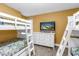 Bedroom featuring bunk beds, a dresser, and a television at 6600 Sunset Way # 118, St Pete Beach, FL 33706