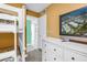 Bedroom featuring bunk beds, a dresser with a television, and an open doorway at 6600 Sunset Way # 118, St Pete Beach, FL 33706