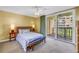 Bright bedroom featuring a bed, balcony access, and views at 6600 Sunset Way # 118, St Pete Beach, FL 33706