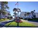 Attractive community entrance with manicured landscaping, palm trees, and clear signage at 6600 Sunset Way # 118, St Pete Beach, FL 33706
