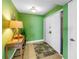Inviting entryway features vibrant green walls, neutral tile floors, and a stylish accent table with decor at 6600 Sunset Way # 118, St Pete Beach, FL 33706