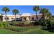 Club house framed by manicured landscaping and tropical palm trees at 6600 Sunset Way # 118, St Pete Beach, FL 33706