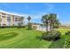 Lush grounds with tall palm trees and a pool area, offering a serene setting at 6600 Sunset Way # 118, St Pete Beach, FL 33706