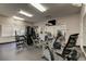 Fully-equipped gym with cardio machines, weightlifting stations, wall-mounted TV, and mirrored wall to keep you in shape at 6600 Sunset Way # 118, St Pete Beach, FL 33706
