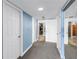 Hallway features carpet flooring, blue accent walls, and white doors and trim at 6600 Sunset Way # 118, St Pete Beach, FL 33706