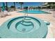 Inviting hot tub with blue tile and clear water, perfect for unwinding in a resort-style setting at 6600 Sunset Way # 118, St Pete Beach, FL 33706