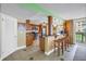 Stylish kitchen with granite countertops, breakfast bar, stainless appliances, and a view to the outdoors at 6600 Sunset Way # 118, St Pete Beach, FL 33706
