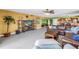 Spacious living room flowing into the kitchen with comfortable seating and a large entertainment center at 6600 Sunset Way # 118, St Pete Beach, FL 33706
