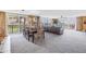 Bright, open living area features floor-to-ceiling sliding glass doors, dining table, and comfortable seating at 6600 Sunset Way # 118, St Pete Beach, FL 33706
