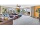 Expansive living room featuring balcony access with breathtaking ocean views and comfortable seating at 6600 Sunset Way # 118, St Pete Beach, FL 33706