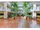 Elegant atrium with lush tropical plants and tiled floors, creating a serene and inviting atmosphere at 6600 Sunset Way # 118, St Pete Beach, FL 33706