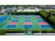 Aerial view of community pickleball courts, showing vibrant courts and surrounding landscaping at 6600 Sunset Way # 118, St Pete Beach, FL 33706